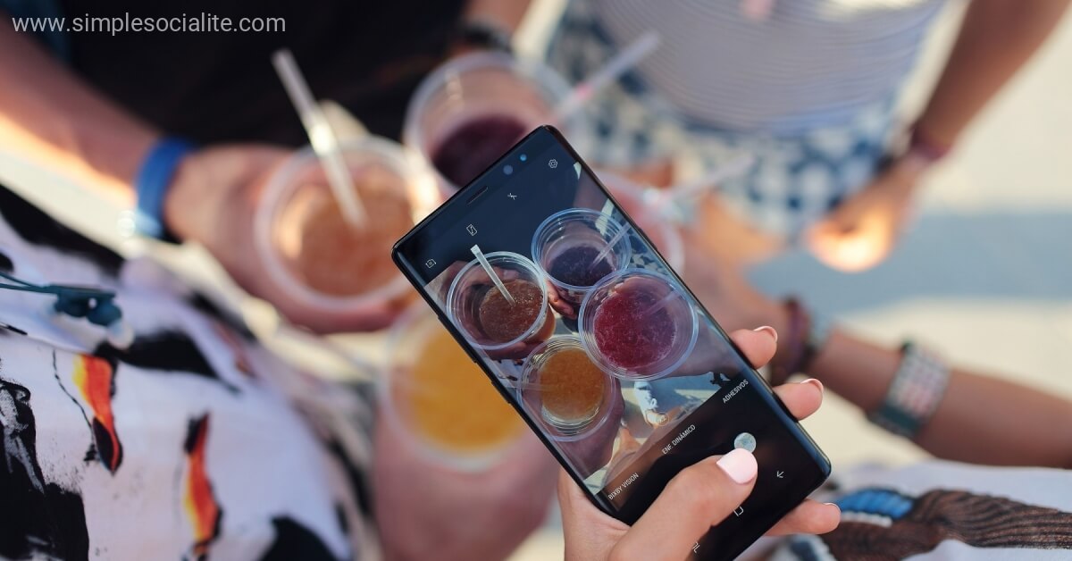Phone snapping photo a drinks to share with social media followers