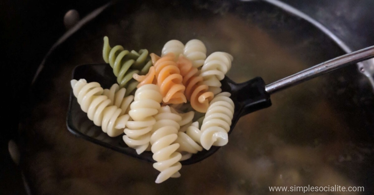 Spoonful of boiling rotini noodles