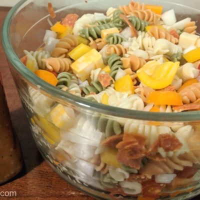 Bowl of Rotini Pasta Salad with Italian Dressing next to it
