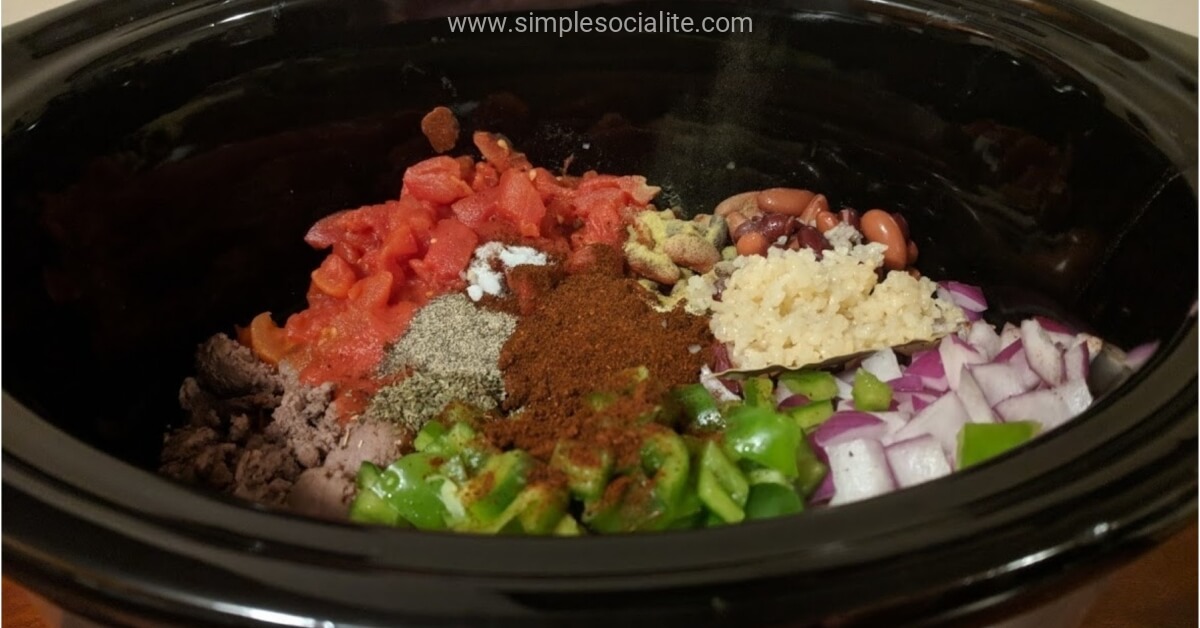 Chopped up turkey chili ingredients in a slow cooker